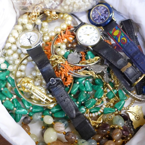 658 - A case of costume jewellery including a coral necklace, wristwatches, etc.