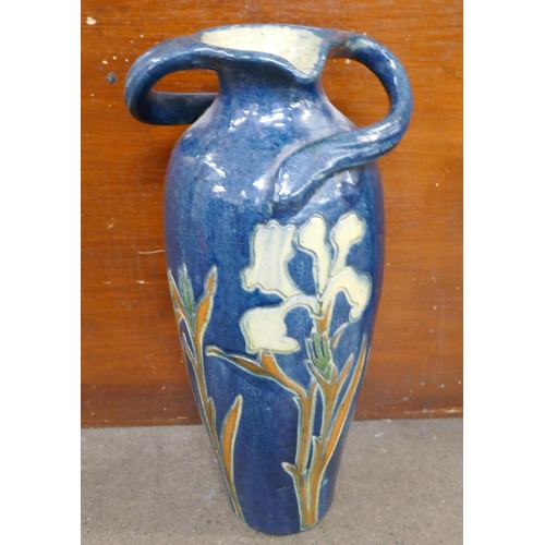 710 - A large Art Nouveau pottery vase, rim restored, a Bretby planter, restored and an orange Branham pot... 