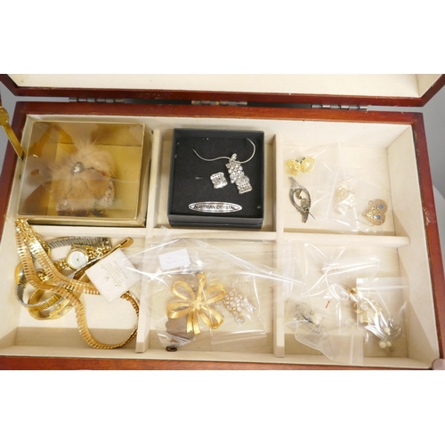 725 - A collection of costume jewellery and three lady's wristwatches, in a jewellery cabinet