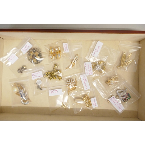 725 - A collection of costume jewellery and three lady's wristwatches, in a jewellery cabinet