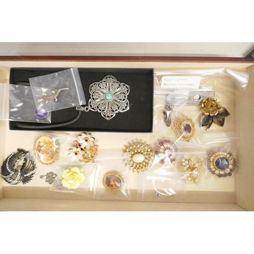 725 - A collection of costume jewellery and three lady's wristwatches, in a jewellery cabinet