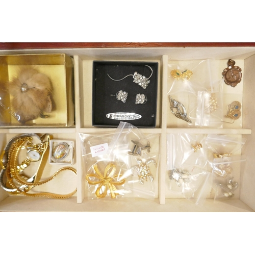 725 - A collection of costume jewellery and three lady's wristwatches, in a jewellery cabinet