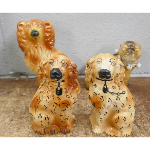 730 - A pair of brown Staffordshire spaniels, eight single spaniels and other Staffordshire dogs, some a/f... 