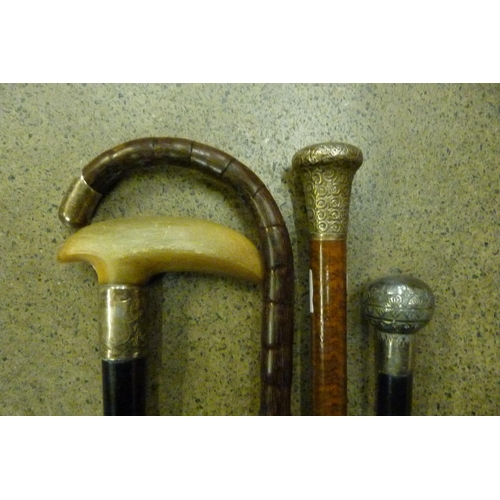 731A - Two topped walking canes, a horn handle cane with silver collar and an umbrella