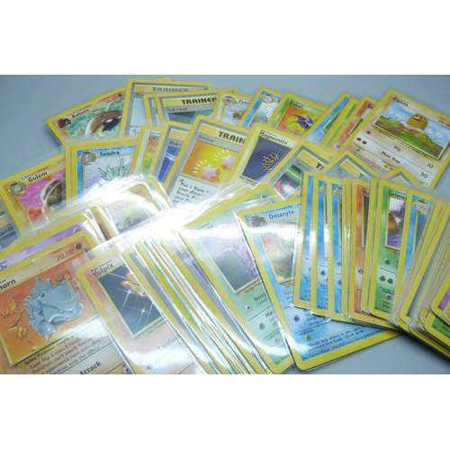 741 - Ninety vintage Pokemon cards, sets Fossil, base set, Rocket, Jungle, etc.