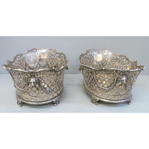 753 - A pair of Victorian pierced silver baskets with lion head ring handles and ram and swags details, ea... 