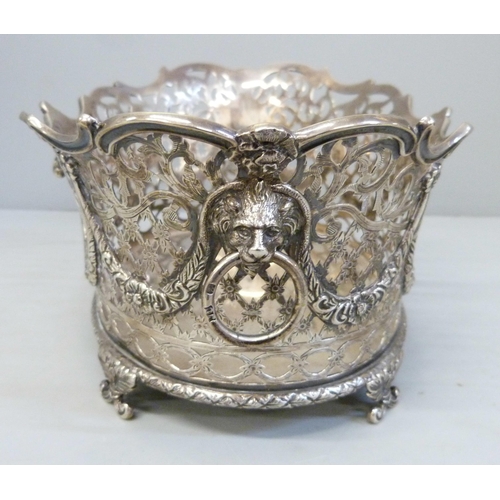 753 - A pair of Victorian pierced silver baskets with lion head ring handles and ram and swags details, ea... 