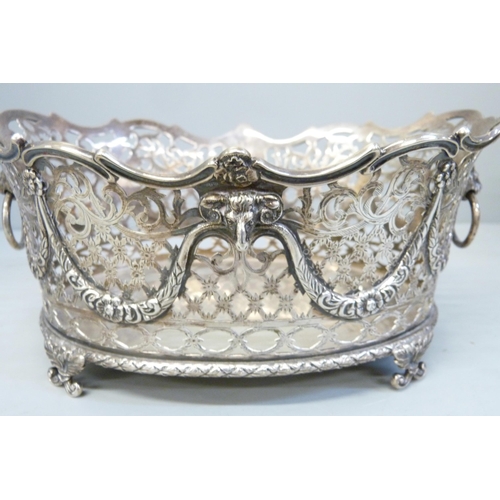 753 - A pair of Victorian pierced silver baskets with lion head ring handles and ram and swags details, ea... 