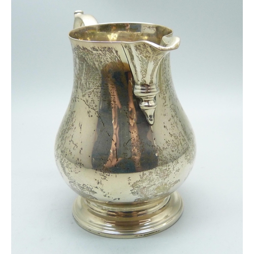 764 - A silver cream jug, Birmingham 1932, Adie Bros., 143g