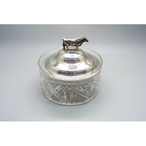 766 - A silver topped glass dish with bull detail, top 83g