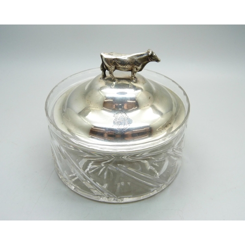 766 - A silver topped glass dish with bull detail, top 83g