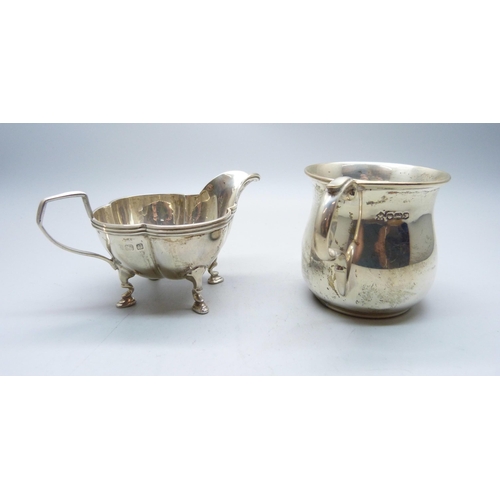 773 - A silver jug and a small silver mug, 133g, mug with initials and dented