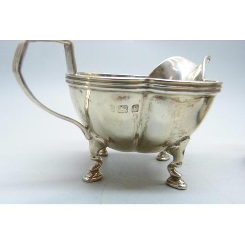 773 - A silver jug and a small silver mug, 133g, mug with initials and dented