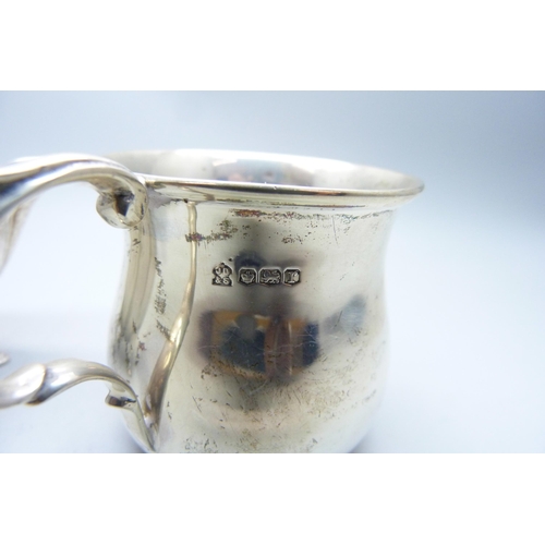 773 - A silver jug and a small silver mug, 133g, mug with initials and dented