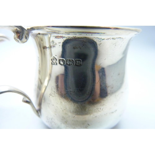 773 - A silver jug and a small silver mug, 133g, mug with initials and dented