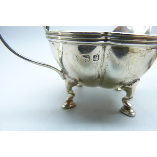 773 - A silver jug and a small silver mug, 133g, mug with initials and dented