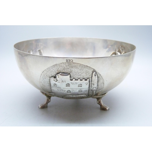 782 - An 830 silver bowl on three feet and with three circular panels with double headed eagle, Corinthian... 