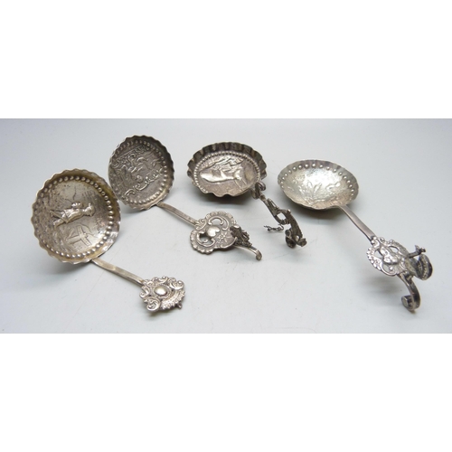 800 - Three continental silver spoons, each with c.1900 import marks and scenes to the bowls, and one othe... 