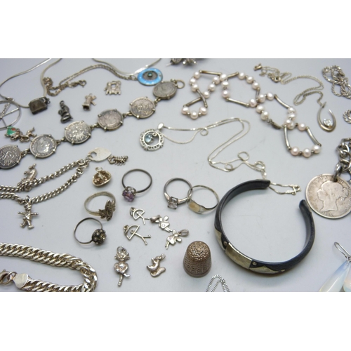 828 - A collection of silver rings, pendants and bracelets including a charm bracelet with loose charms, (... 