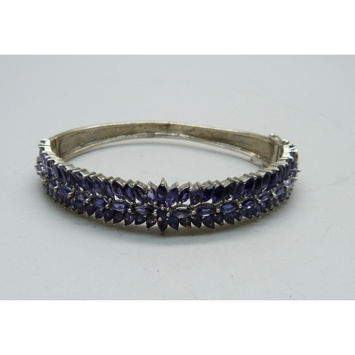 836 - A silver bangle set with purple stones, a/f dented and split, 25g