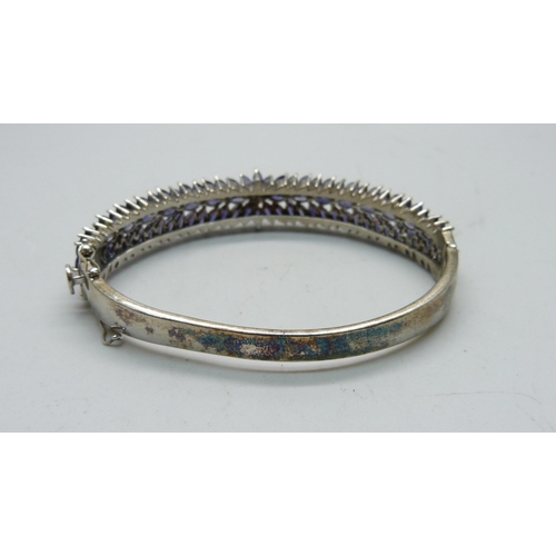 836 - A silver bangle set with purple stones, a/f dented and split, 25g