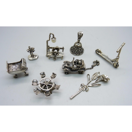 839 - Five .800 silver miniatures, a 925 silver pram, an unmarked white metal bell and an unmarked white m... 