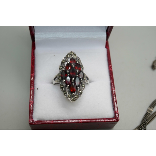 851 - A silver, garnet and marcasite ring, four pairs of garnet and marcasite earrings (two pairs with mar... 