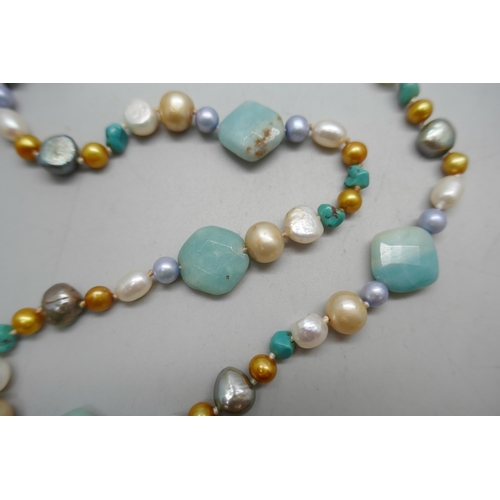 864 - A pearl and gemstone necklace with silver clasp