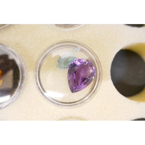 867 - A collection of gemstones including amethysts, opals, citrine, topaz etc.