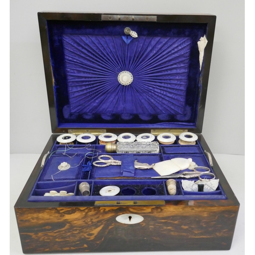 868 - A coromandel sewing box with a large collection of sewing related items, mother of pearl cotton reel... 