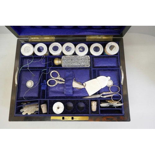 868 - A coromandel sewing box with a large collection of sewing related items, mother of pearl cotton reel... 