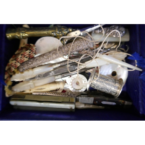 868 - A coromandel sewing box with a large collection of sewing related items, mother of pearl cotton reel... 