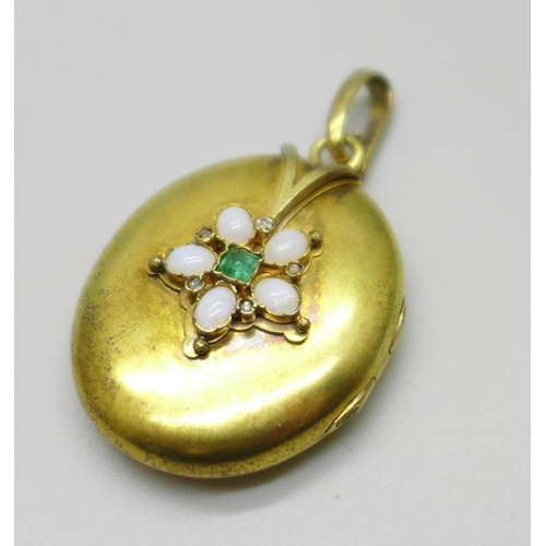 An early 20th Century yellow metal locket set with opals, emerald and ...