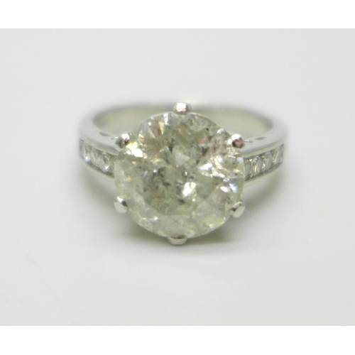 994 - A hallmarked platinum solitaire diamond ring with diamond set shoulders, 3.80cts, 6.2g, M