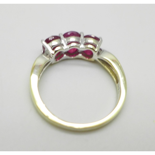 999 - A silver gilt, ruby and white stone ring, S