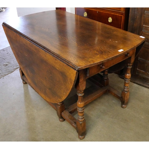 104 - A George III style oak gateleg dining table