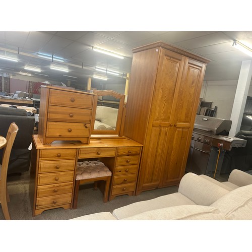 1555 - A pine double wardrobe, dressing table, mirror, stool and a bedside chest