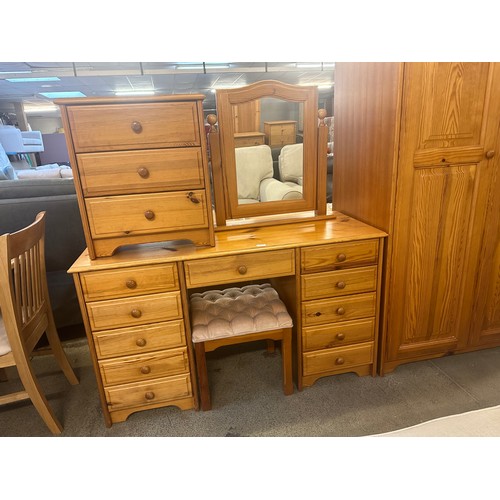 1555 - A pine double wardrobe, dressing table, mirror, stool and a bedside chest