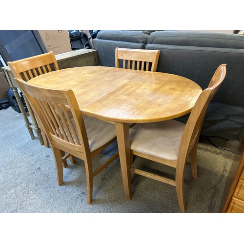 1556 - A beech extending dining table and four chairs