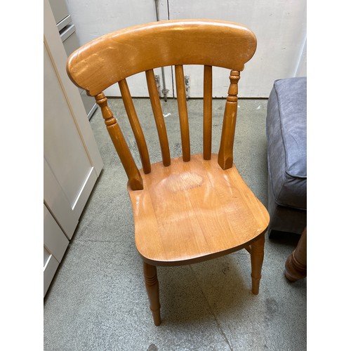 1566 - A pine dining table and six slat back chairs