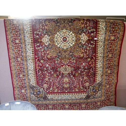 1491 - A red ground full pile Mashad carpet, floral medallion design