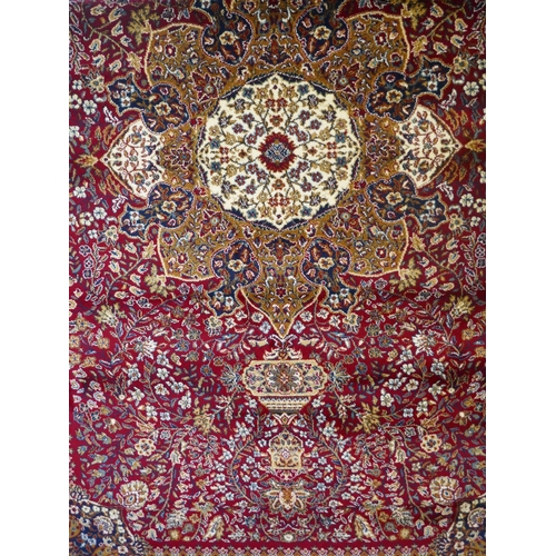 1491 - A red ground full pile Mashad carpet, floral medallion design