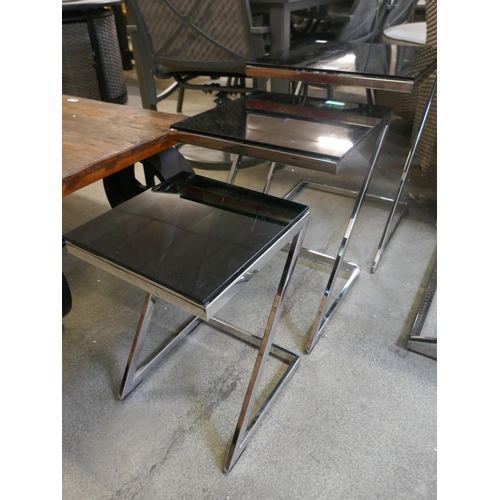 1493 - A chrome and black glass nest of tables *This lot is subject to VAT