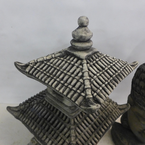 2183 - A 65cm, two tier antique effect concrete pagoda and a 60cm antique effect concrete Buddha bust ornam... 