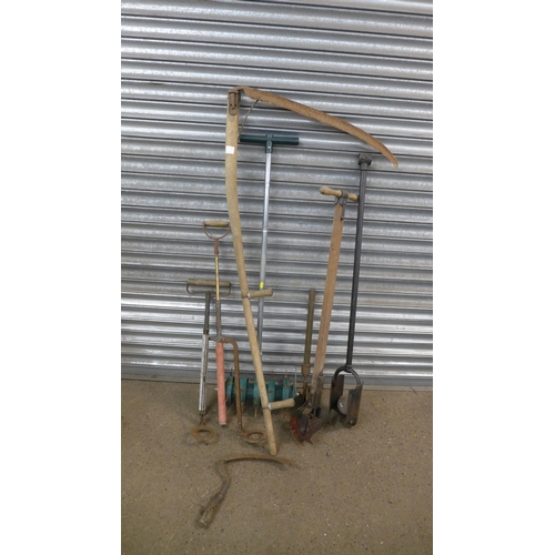 2215A - A bundle of garden tools including scythe, post hole digger, lawn aerator, etc.