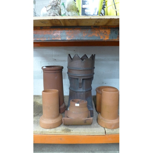 2224 - A collection of terracotta chimney pots in assorted sizes and styles