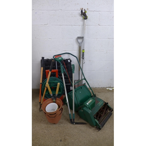 2231 - A collection of gardening tools including a hose pipe, a Qualcast Punch Classic 35 240v electric law... 