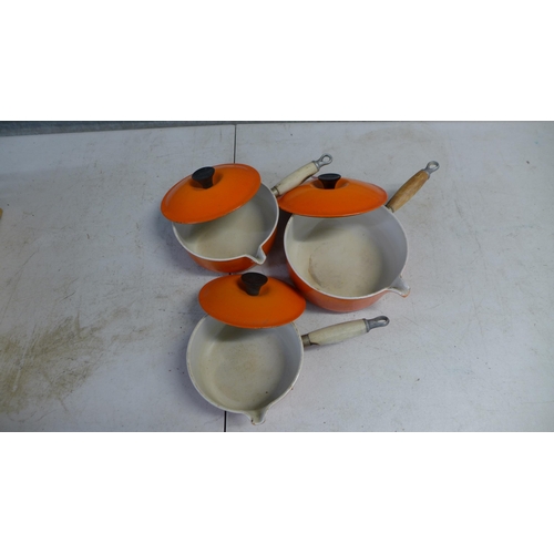 2254A - Three Le Creuset saucepans including an 18cm, 20cm and 22cm saucepan with wooden handles