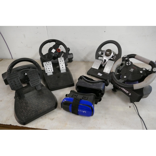 2357 - A quantity of video game steering wheels and pedals including a Snopy Mega Racing wheel and pedals, ... 