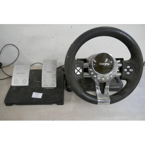 2357 - A quantity of video game steering wheels and pedals including a Snopy Mega Racing wheel and pedals, ... 